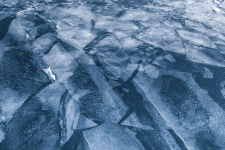 Cracked ice on a river in winterの写真素材