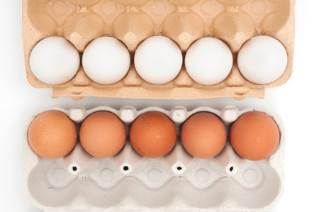 Eggs in carton trayes on white background