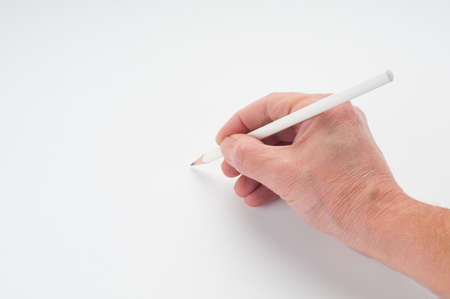 Man`s hand writing with pencil on white backgroundの写真素材