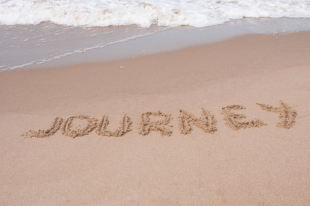 Journey Inscription on a sandy sea coastの写真素材