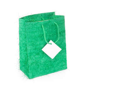 Green gift bag isolated on white backgroundの写真素材
