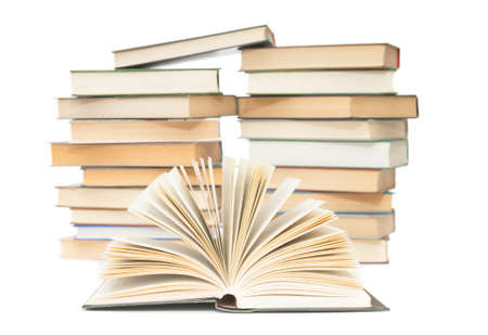 Open book close up and blurred stack of books on white backgroundの写真素材