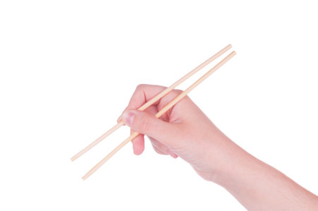 Hand holding chopsticks on white backgroundの写真素材