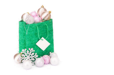 Christmas spheres in green packet on white backgroundの写真素材