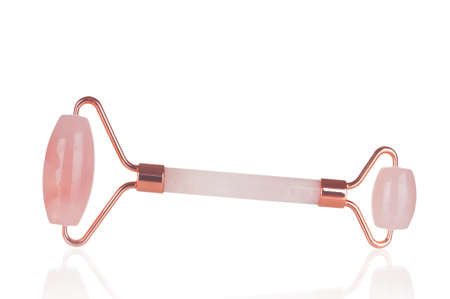 Pink quartz massage roller on white backgroundの写真素材