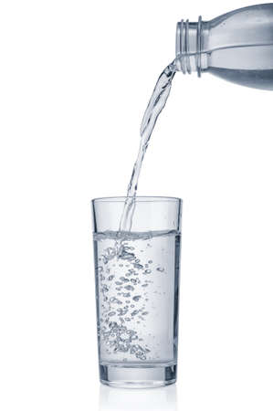 Flowing pure water into glass isolated on white backgroundの写真素材