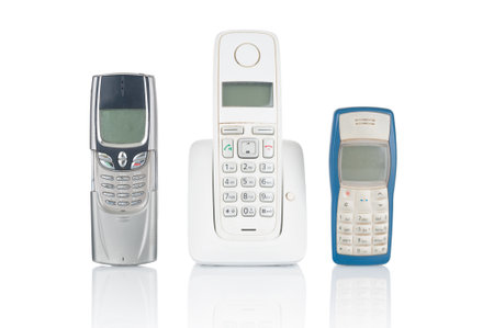 Old used wireless and mobile phones isolated on white backgroundの写真素材