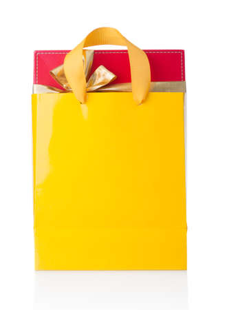 Red gift box in yellow shopping bag on white backgroundの写真素材