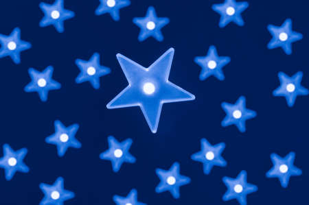 Blue star shaped led lights on dark blue background