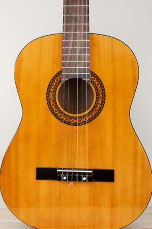 Acoustic guitar close up on gray backgroundの写真素材
