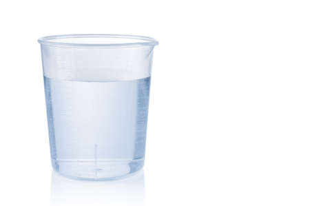 Measuring plastic cup with water isolated on white backgroundの写真素材