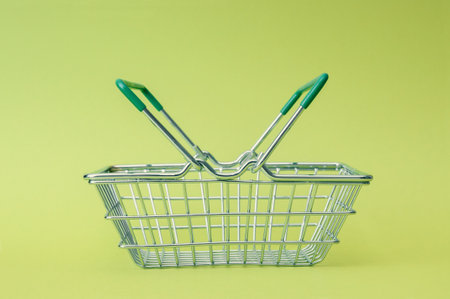 Empty shopping basket close up on green backgroundの写真素材