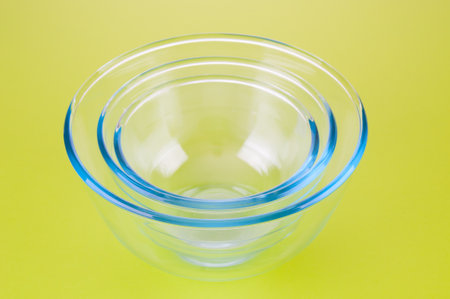 Empty glass food bowls on a green backgroundの写真素材