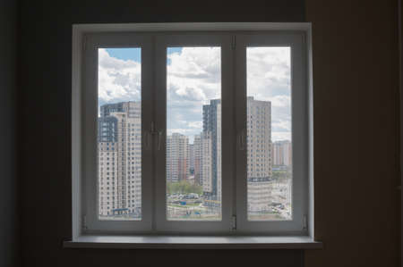 View from window of living room to outside on city housesの写真素材
