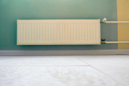 Heating modern radiator in empty living roomの写真素材