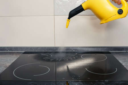 Cleaning of induction cooker with steam cleanerの写真素材