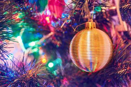 Golden sphere close up on a Christmas tree. christmas cardの写真素材
