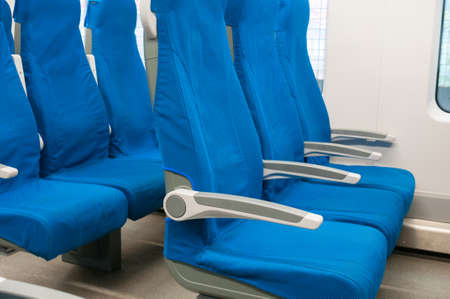 Interior of railway wagon with row comfortable blue seatsの写真素材
