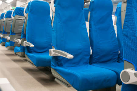 Interior of railway wagon with row comfortable blue seatsの写真素材