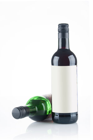 Two red wine bottles close up isolated on white backgroundの写真素材