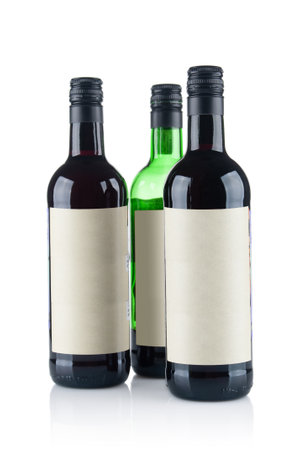 Few red wine bottles close up isolated on white backgroundの写真素材