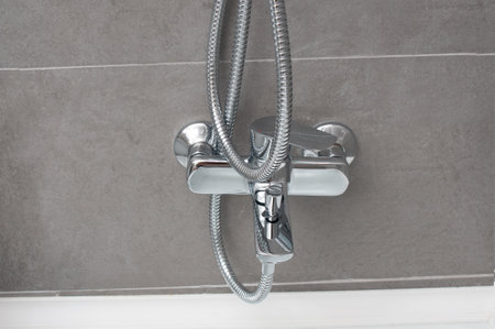 Chrome shower faucet close up in a bathroomの写真素材