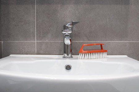 New ceramic sink and chrome faucet in a bathroomの写真素材