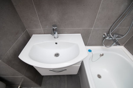New ceramic sink and bathtub in a bathroom. View from aboveの写真素材