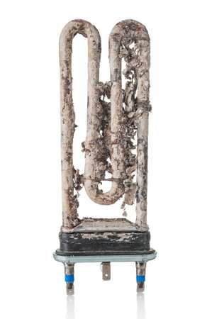 Damaged electric heater of washing machine with scale and sediment on white backgroundの写真素材