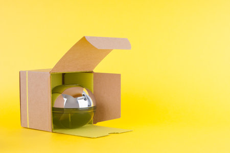 Perfume bottle in cardboard box on yellow backgroundの写真素材