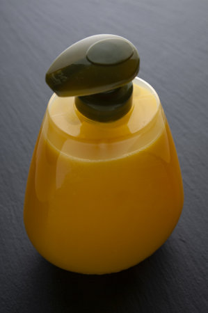 Liquid soap in plastic bottle close up on black backgroundの写真素材