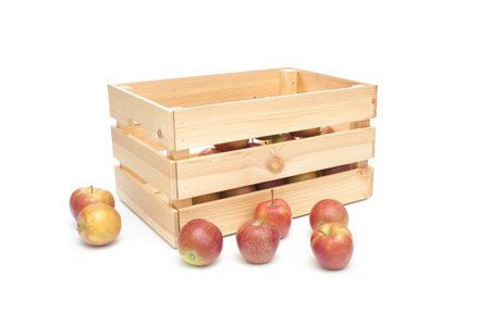 Fresh organic apples in wooden crate isolated on white backgroundの写真素材