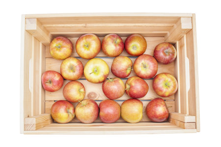 Fresh organic apples in wooden crate isolated on white background. Top viewの写真素材