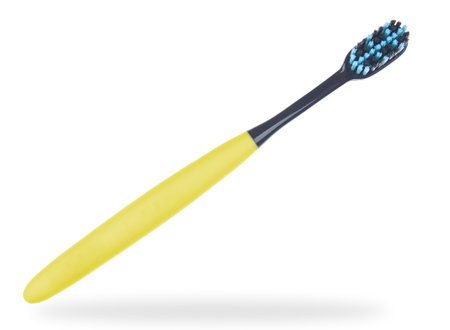 Yellow toothbrush close up isolated on a white backgroundの写真素材