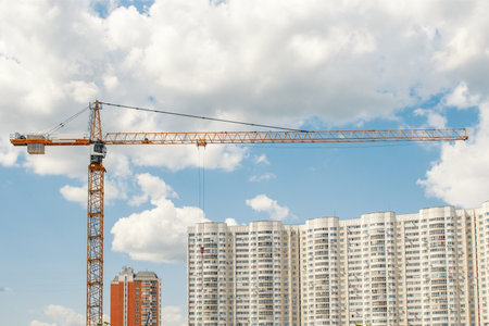 Construction of a new residential houses. Crane and houses under constructionの写真素材