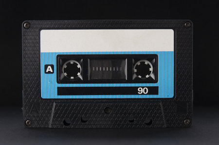 Old vintage audio cassette close up on a black backgroundの写真素材