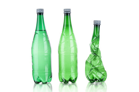 Plastic bottles soda water and wrinkled bottle on white backgroundの写真素材