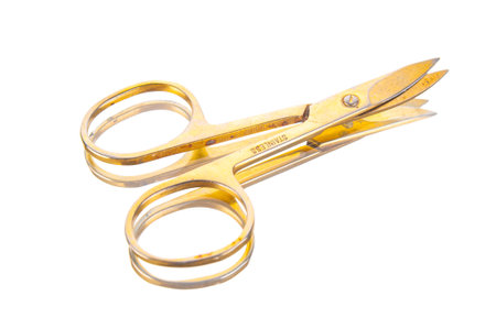 Used yellow nail scissors close up on a white backgroundの写真素材