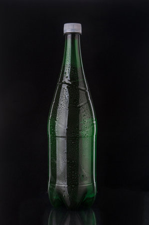 Soda drink bottle close up on black backgroundの写真素材