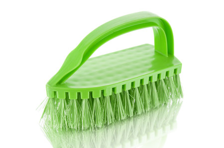 Green cleaning brush close up on a white backgroundの写真素材