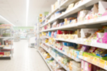 Interior of supermarket aisle and shelves blurred backgroundの写真素材