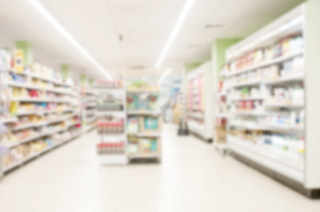 Interior of supermarket aisle and shelves blurred backgroundの写真素材