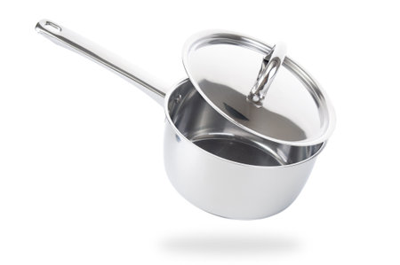 Stainless saucepan with metal lid isolated on white backgroundの写真素材