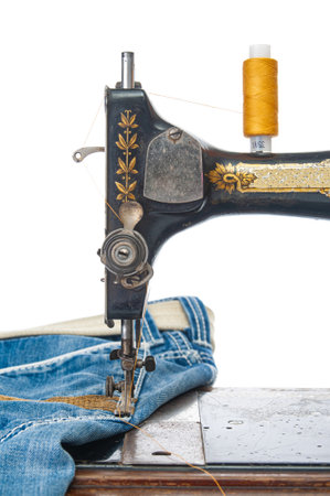 Production of garments with a sewing machine close up on white backgroundの写真素材