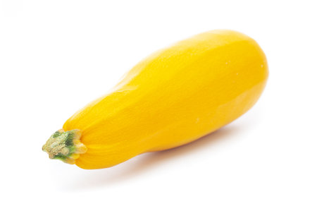Yellow zucchini close up on a white backgroundの写真素材