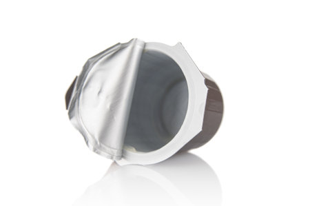 Used disposable plastic container from milk cream on white backgroundの写真素材
