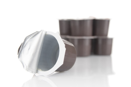 Used disposable plastic containers from milk cream on white backgroundの写真素材