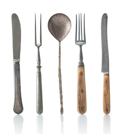 Antique flatware spoon, knife and fork on a white backgroundの写真素材
