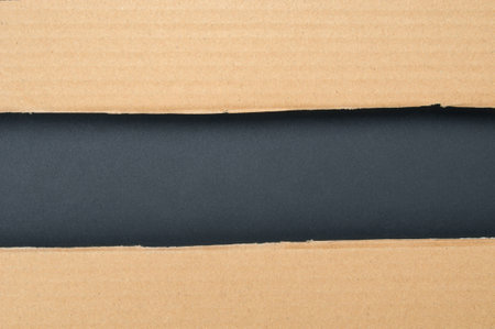 Torn edge cardboard pieces on a black backgroundの写真素材