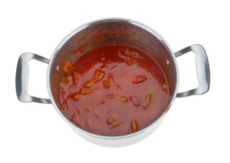 Stewed peppers with sauce in steel saucepan on white backgroundの写真素材